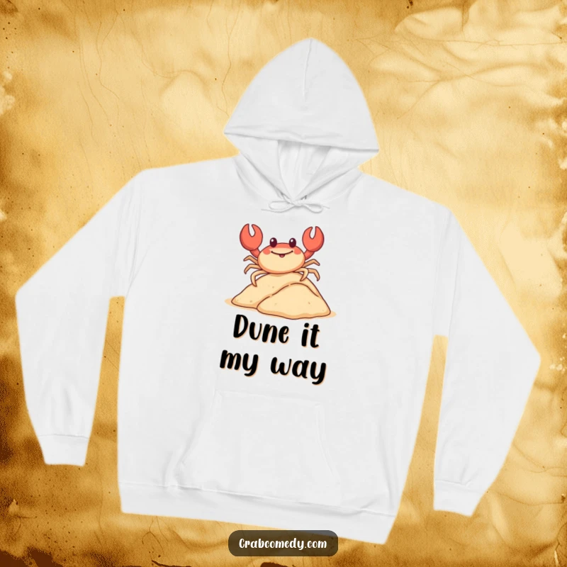 Funny, happy crab sliding down a miniature sand dune on its shell, printed on a hoodie.